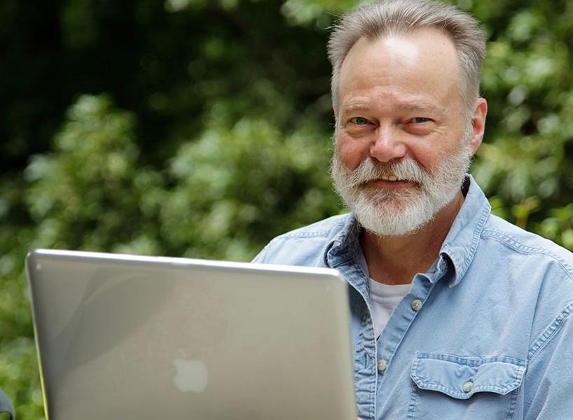 adult education student working on a laptop