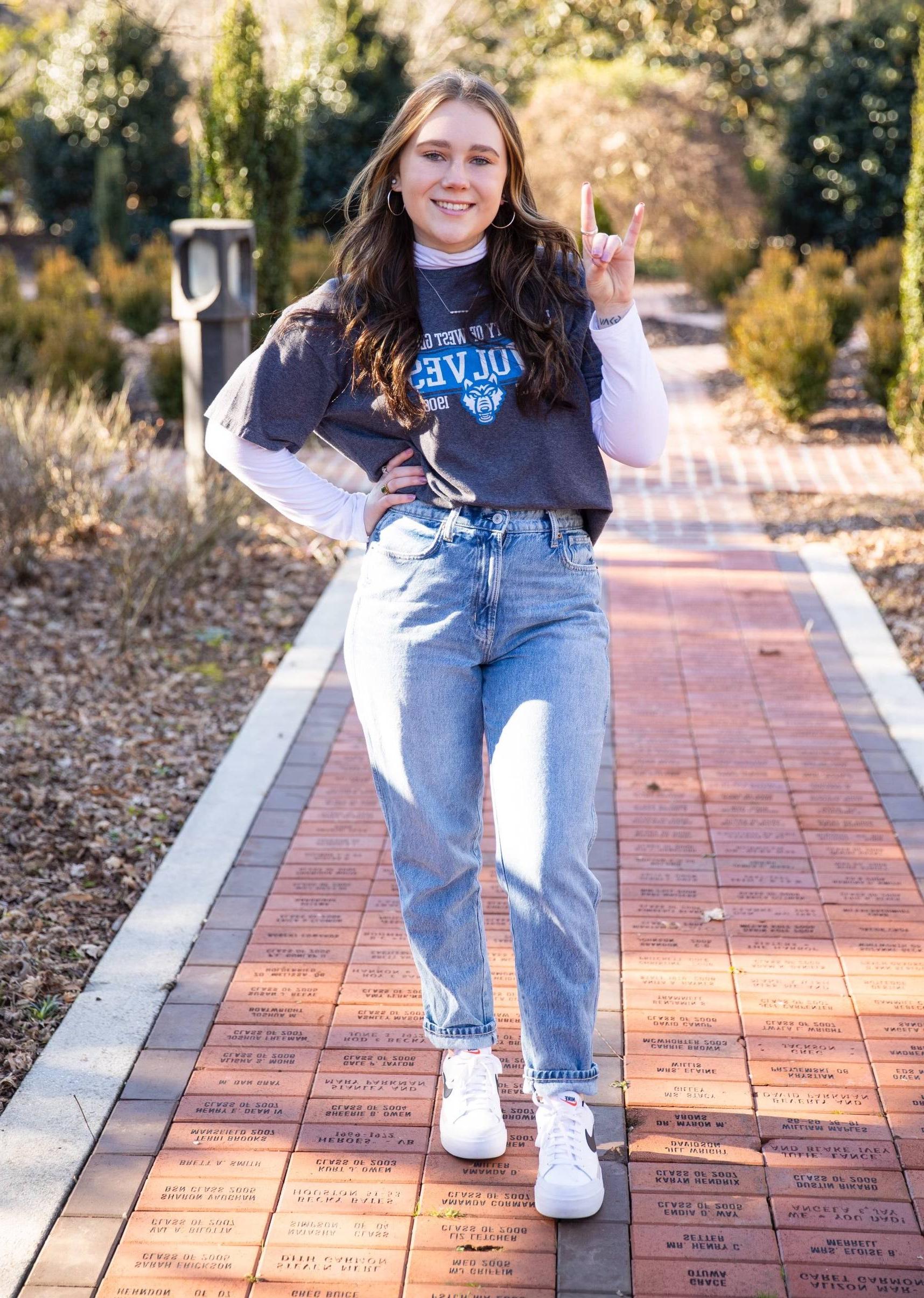 Grace Katherine James posing for an outside portait in the alumni garden.