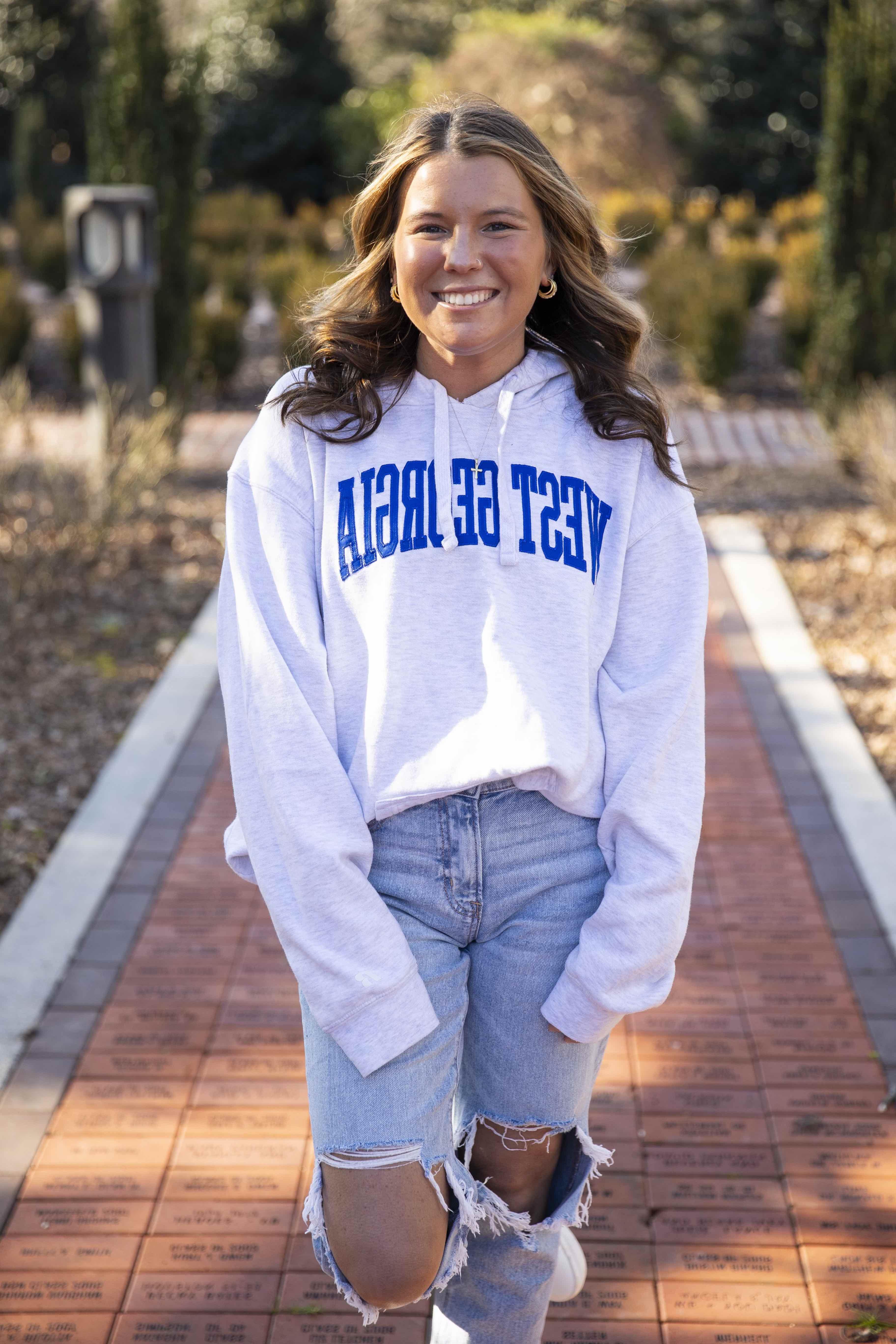 Emily Ficus posing for an outside portait in the alumni garden.